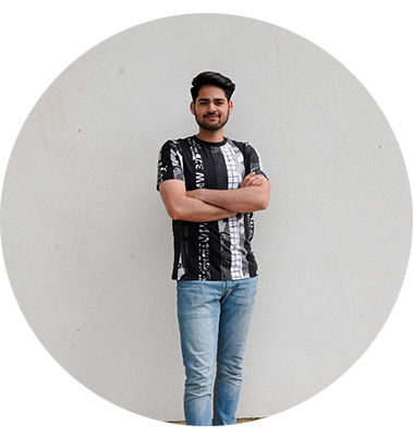 A man standing with his arms crossed in front of a cream background