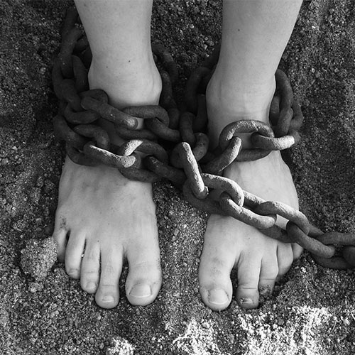 Photo of legs bound in chains