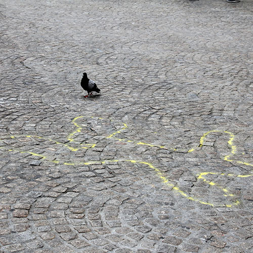 Photo of forensic outline of a body on the ground