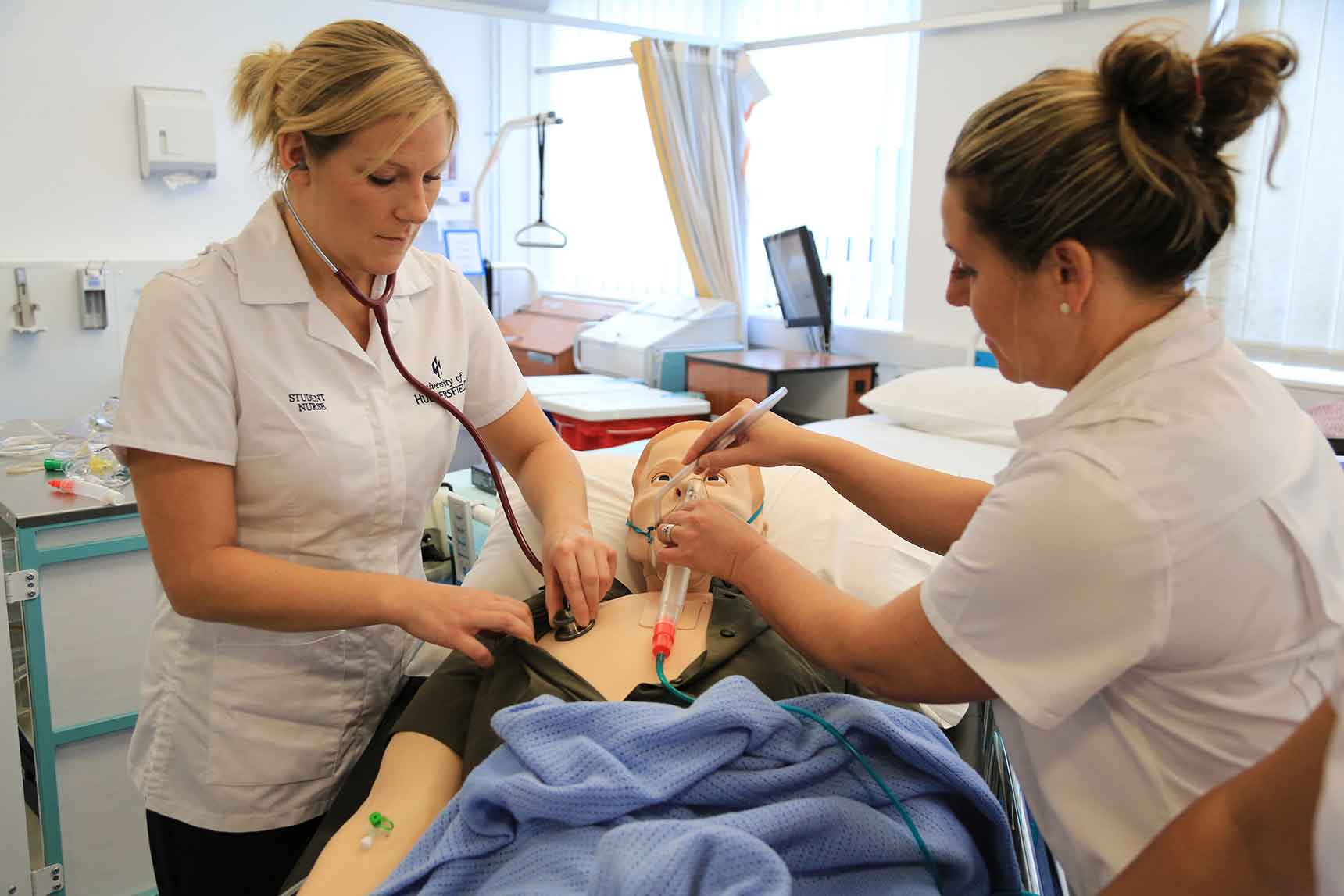Students nurses practice on a mannequin